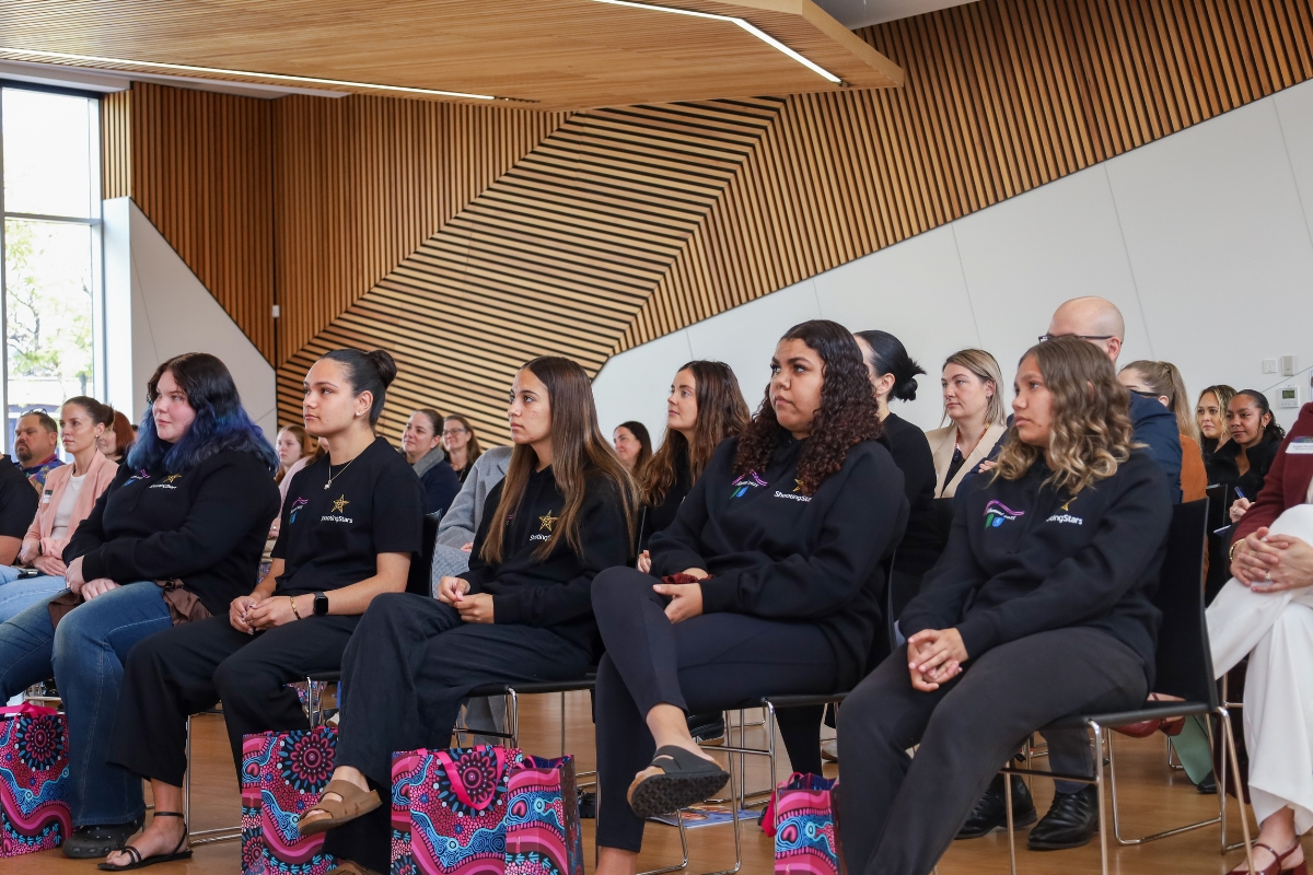 Participants and supporters in crowd at Alumni Graduation