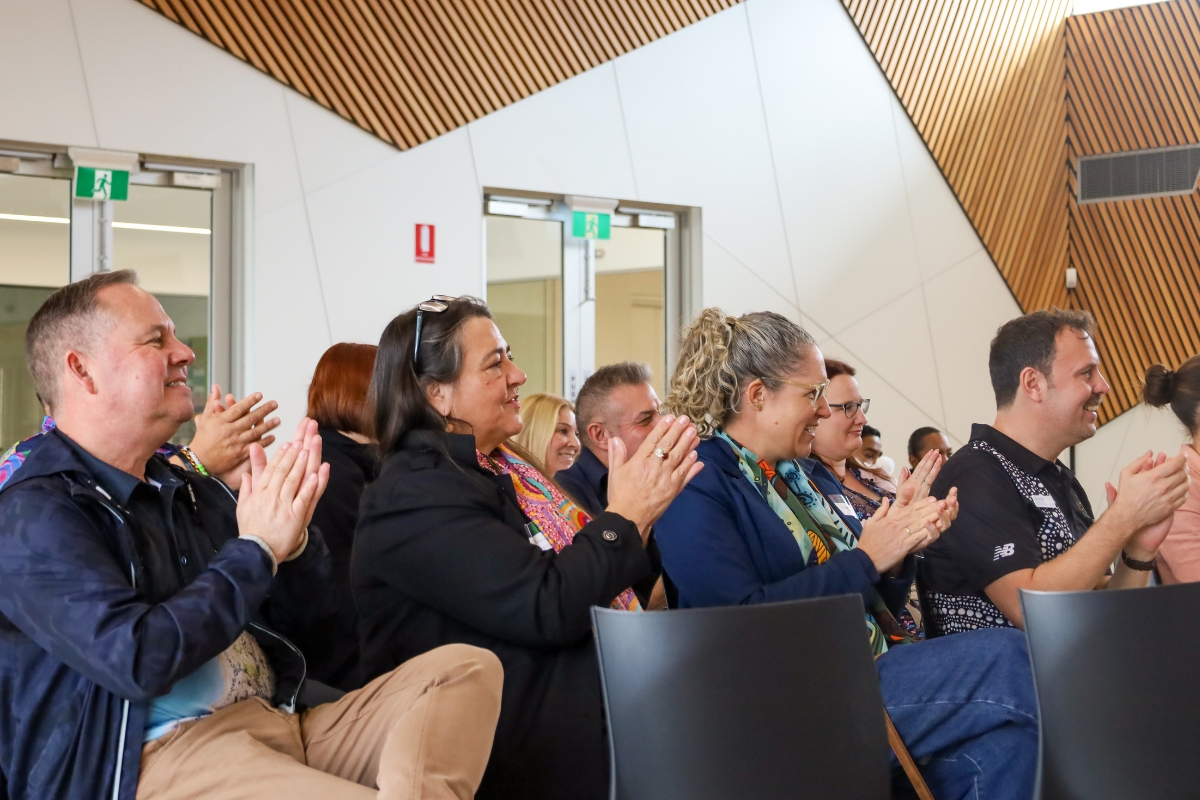 Program partners in the crowd clapping at Alumni Graduation