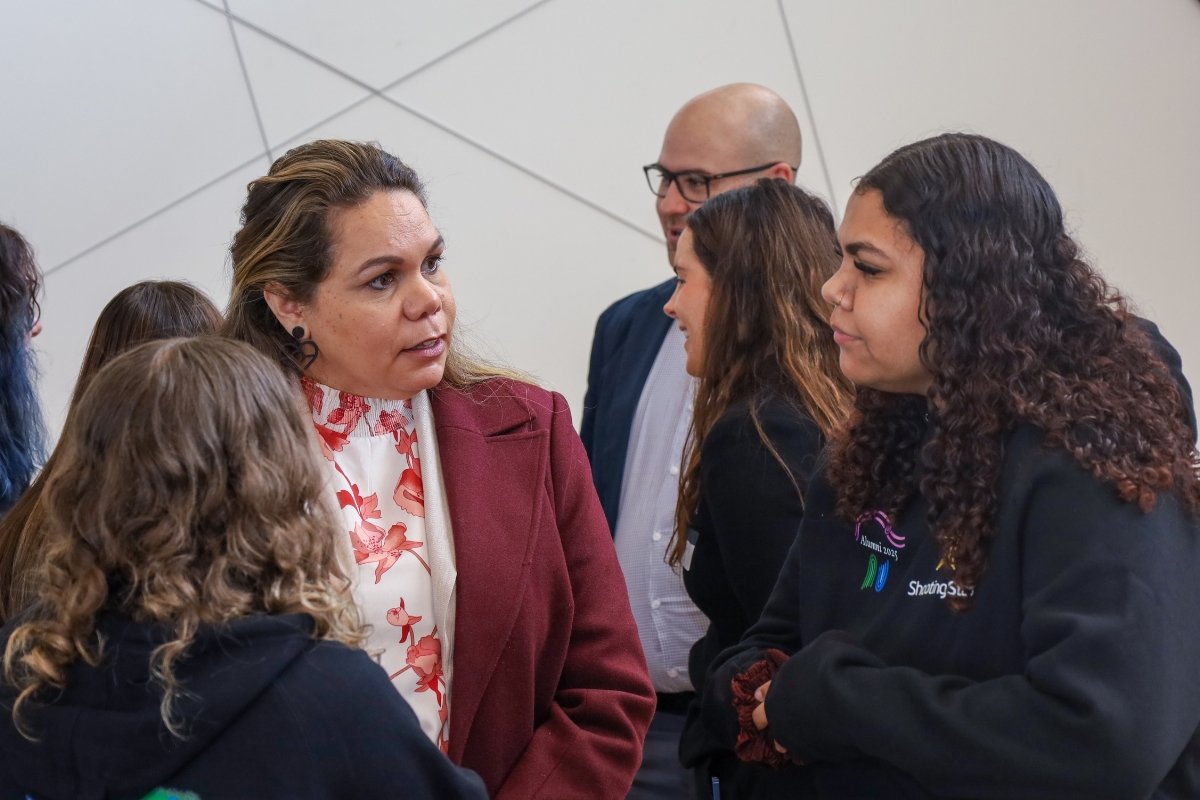 Graduates speaking with Shooting STars partners at Alumni graduation