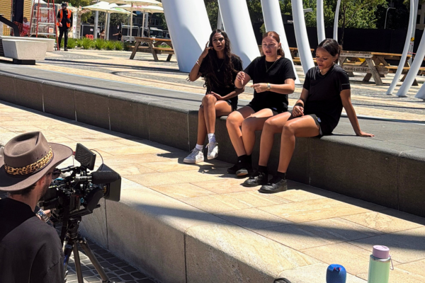 Kiara College participants singing while music video is being filmed