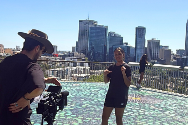 Kiara College participant singing while music video is being filmed